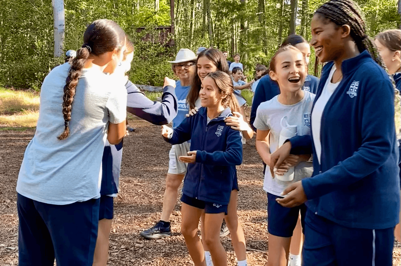 Students laughing together outdoors on a class trip