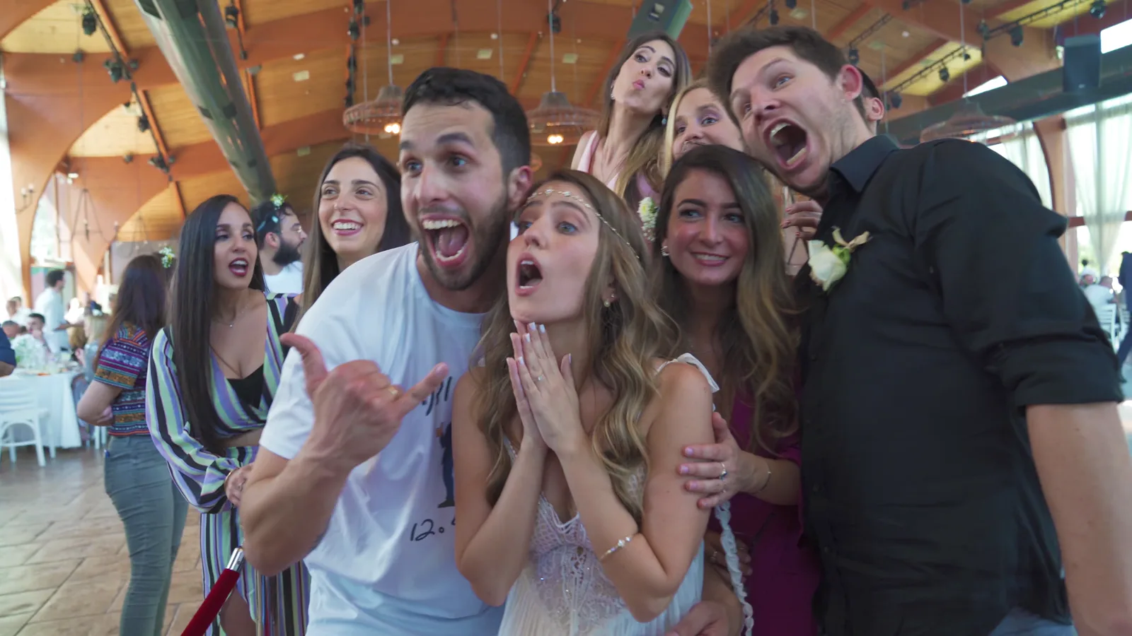 Wedding guests laughing and celebrating together.
