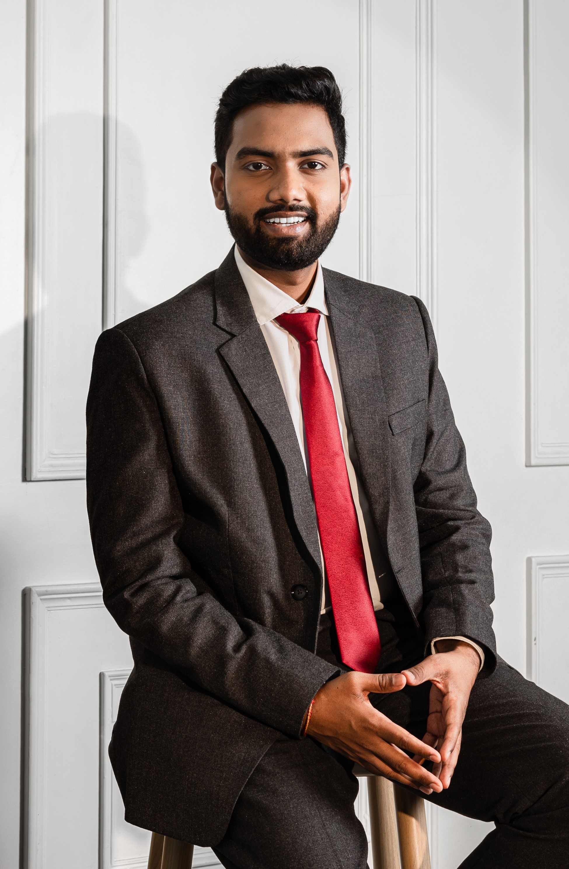 man in black suit jacket holding brown leather bag