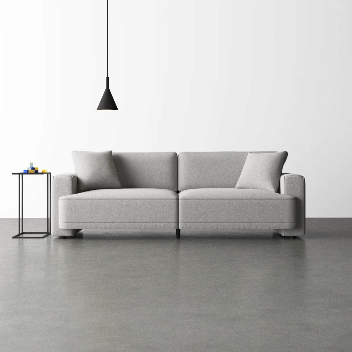 Ives 90" upholstered deep sofa with recessed arms with a minimalist design, set against a white wall & concrete floor