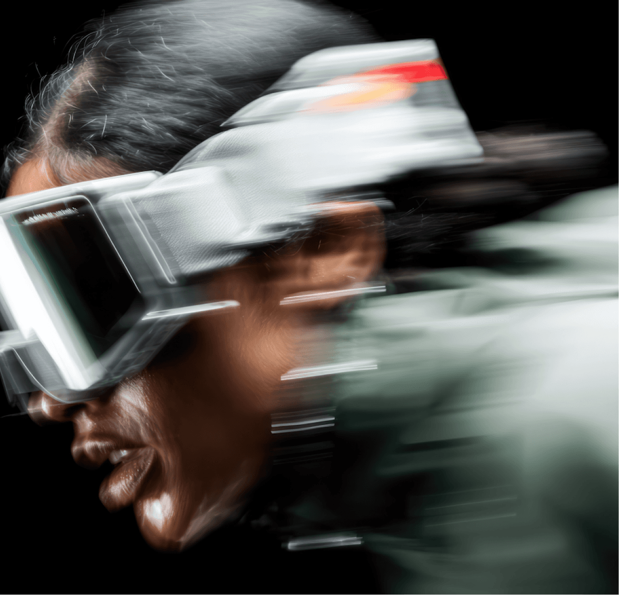 A woman in goggles and a helmet is sprinting forward, showcasing determination and focus in her athletic pursuit.