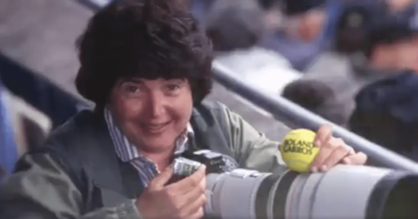 Carol Newsome, the first female professional photographer on tour pictured here at the French Open. She is the subject of a new retrospection at the International Tennis Hall of Fame (ITHF): Hit Me With Your Best Shot! beginning on March 22.