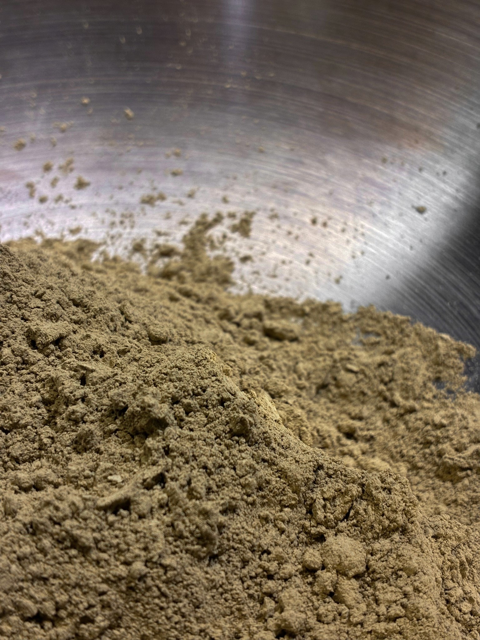 Organic henna powder being mixed to create natural henna paste in Singapore.