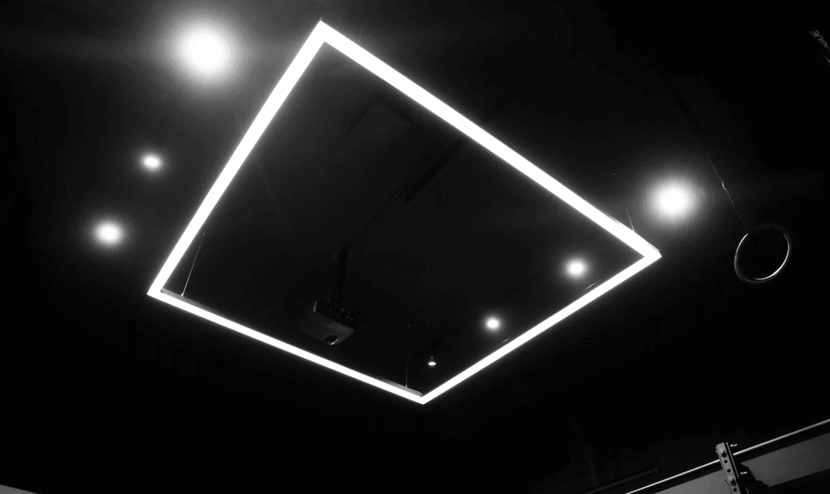 Custom home gym build with custom overhead lighting feature.