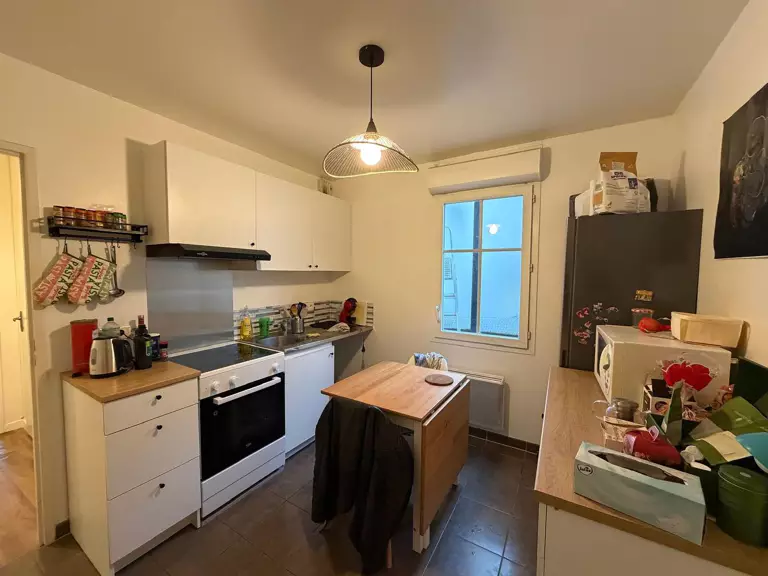 A serene backyard with a pool, sun loungers, and olive trees, set against a warm, sunny landscape.