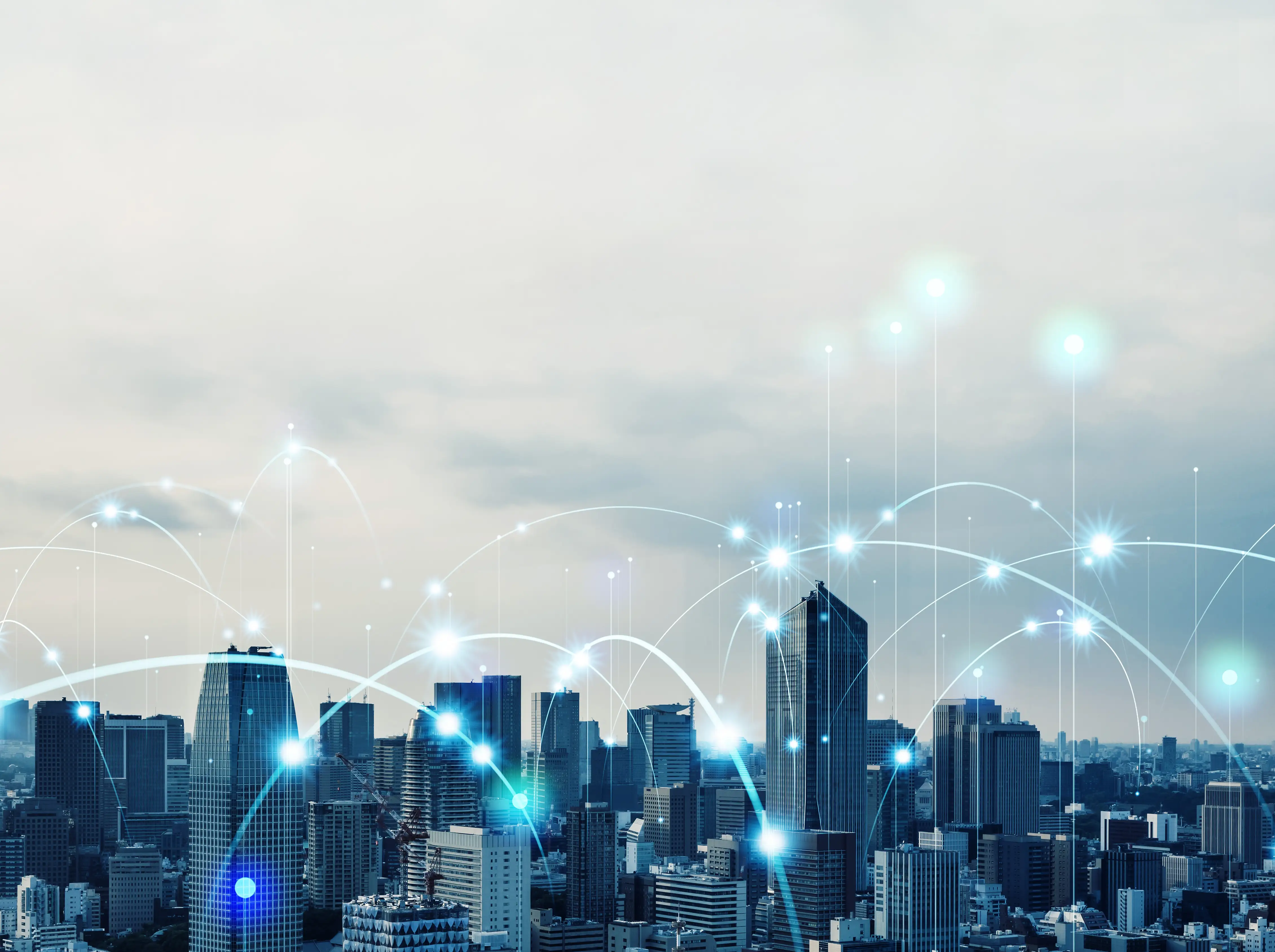 City skyline with digital connection lines and glowing network points representing connectivity