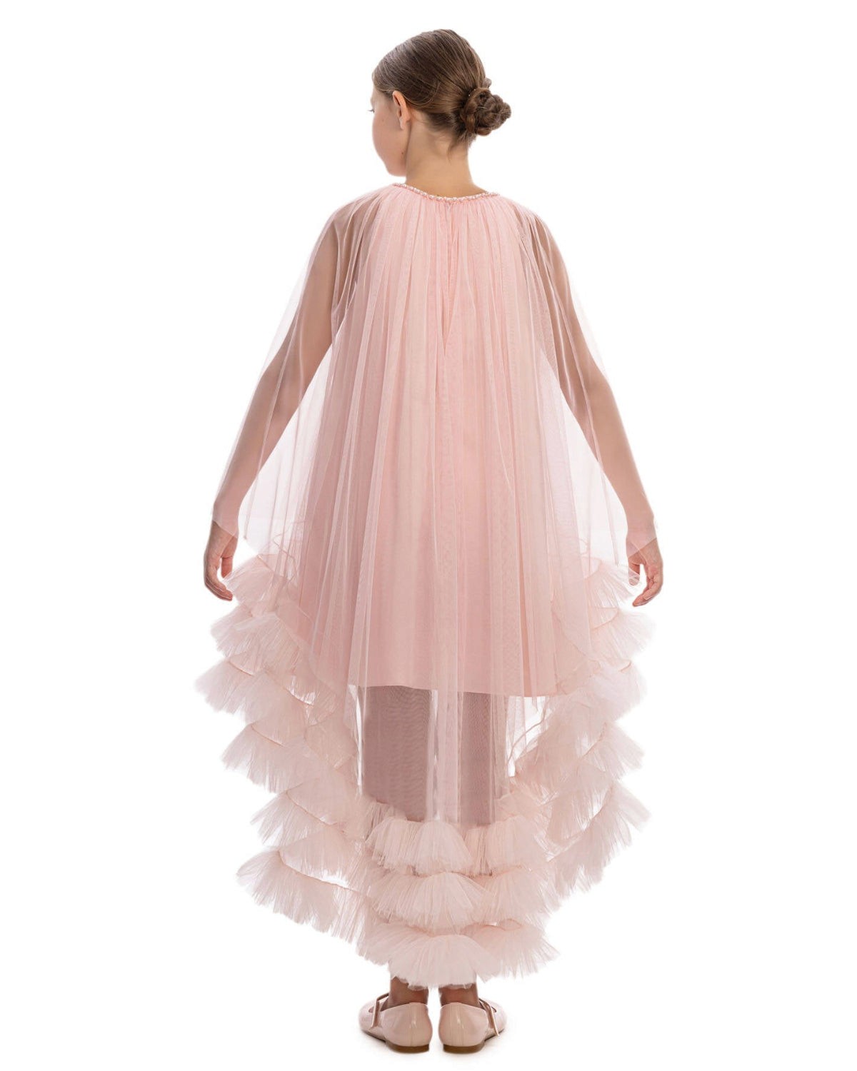 Pink ruffled dress worn by a model on a white background