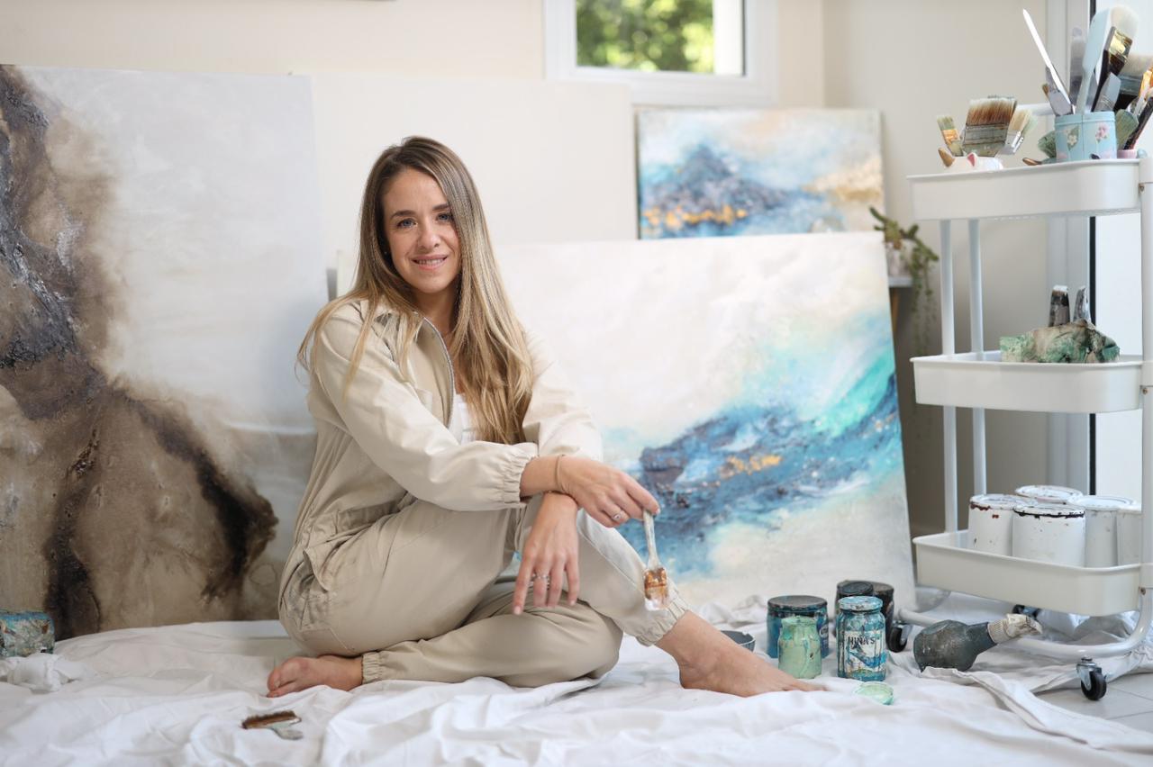 Picture of Lorena Matarraz sitting in her painting workshop