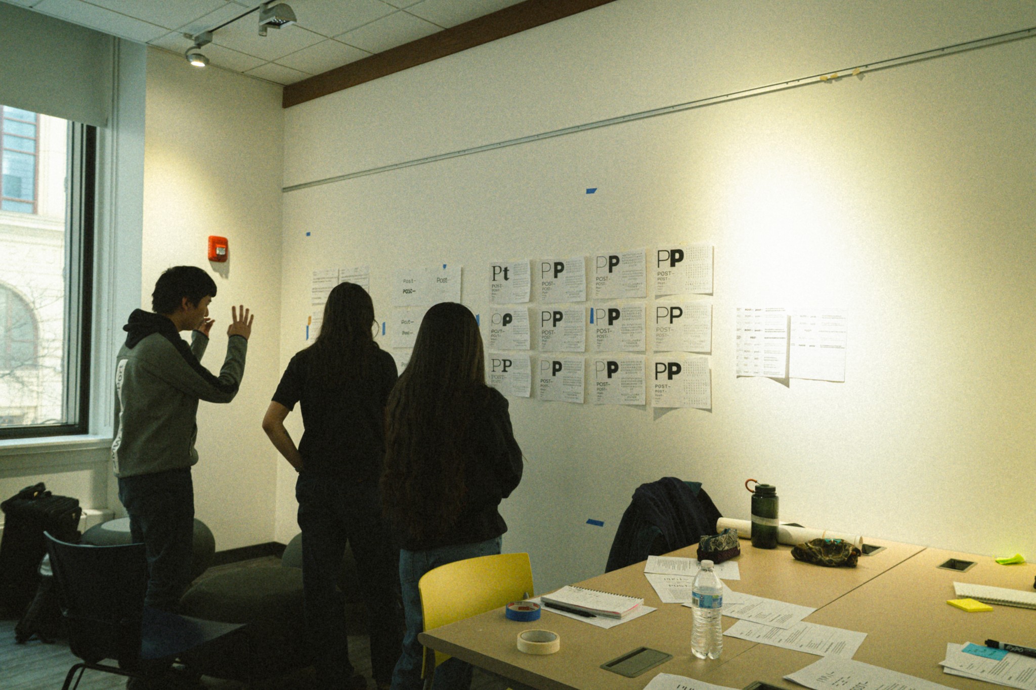 selective focus photography of people sits in front of table inside room