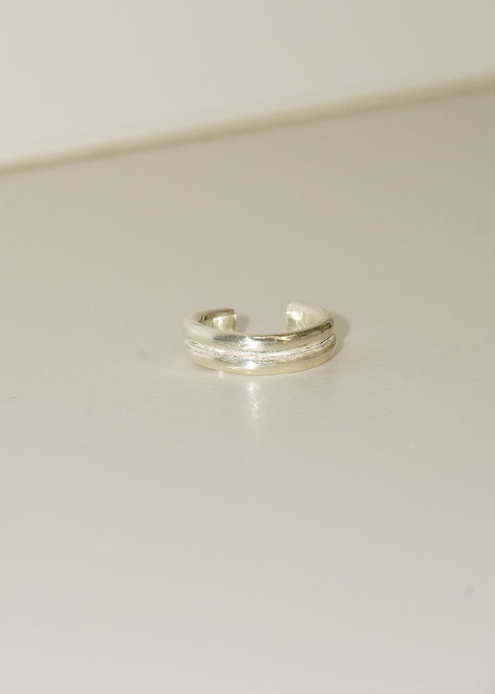 Silver ring on a light gray background