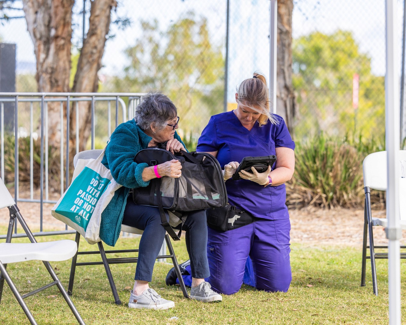 Vet nurse talking to customer with cat carrier