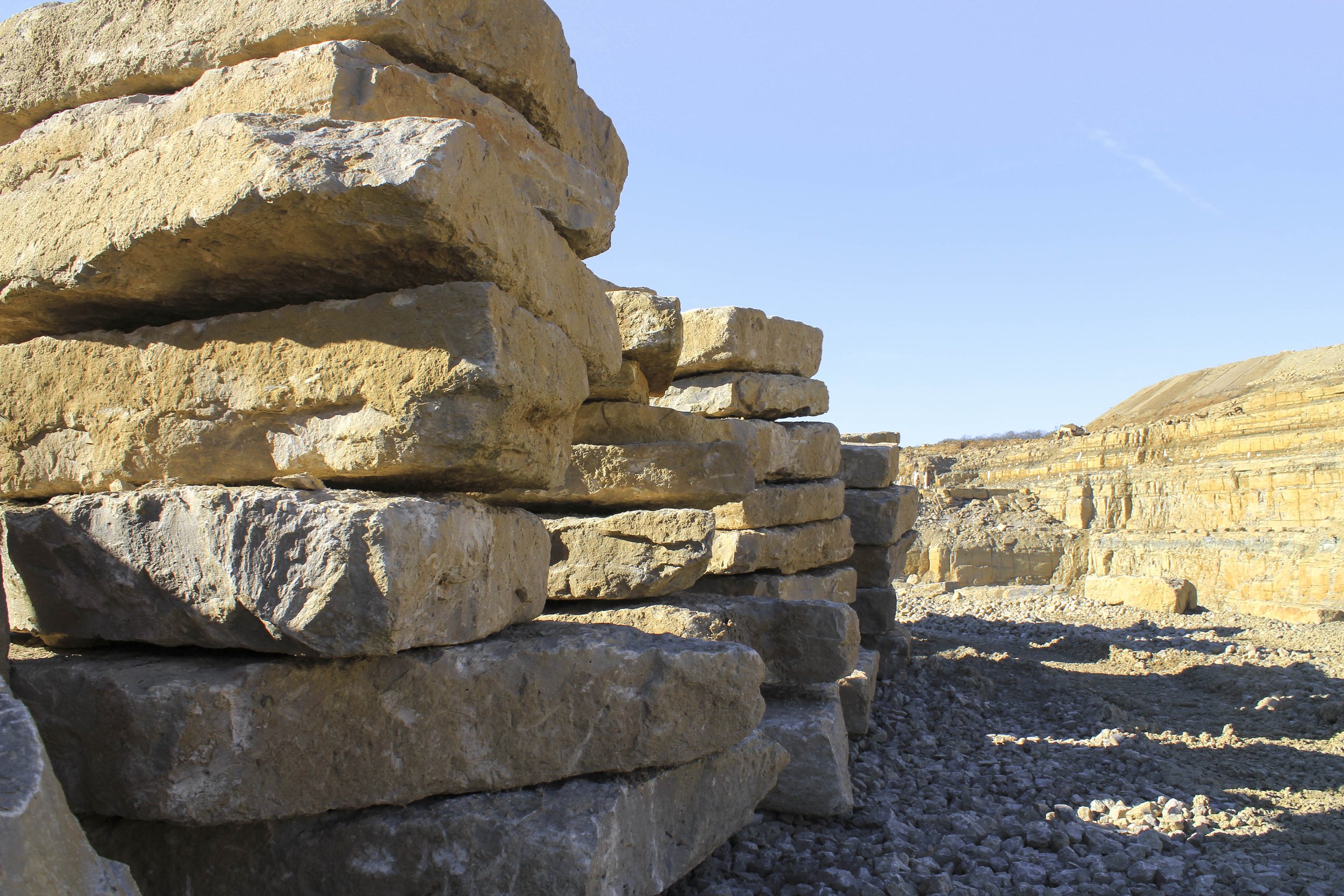 A person holding a wooden tray with two ceramic cups on it