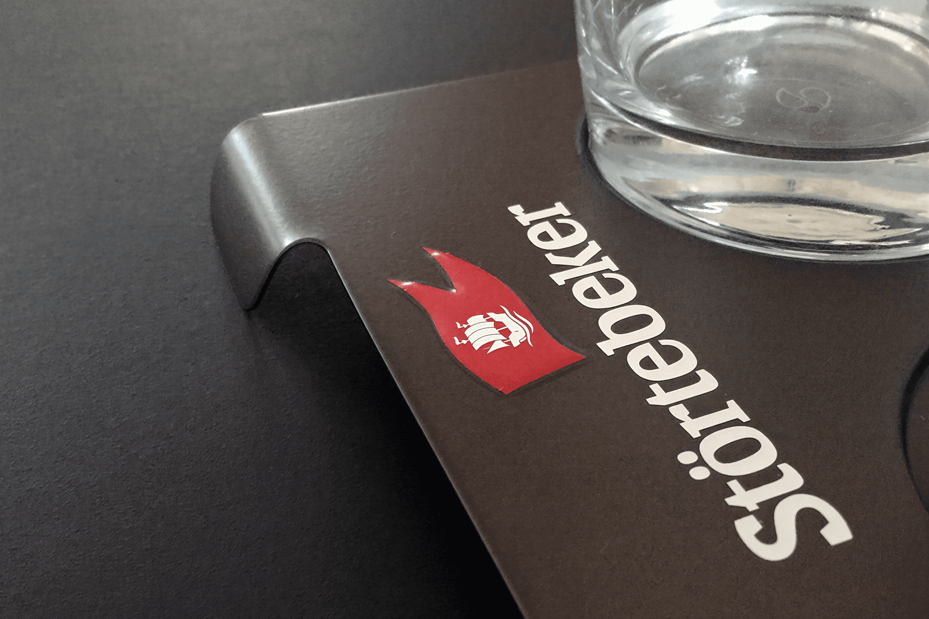 Glass with a Störtebeker logo and ship emblem.