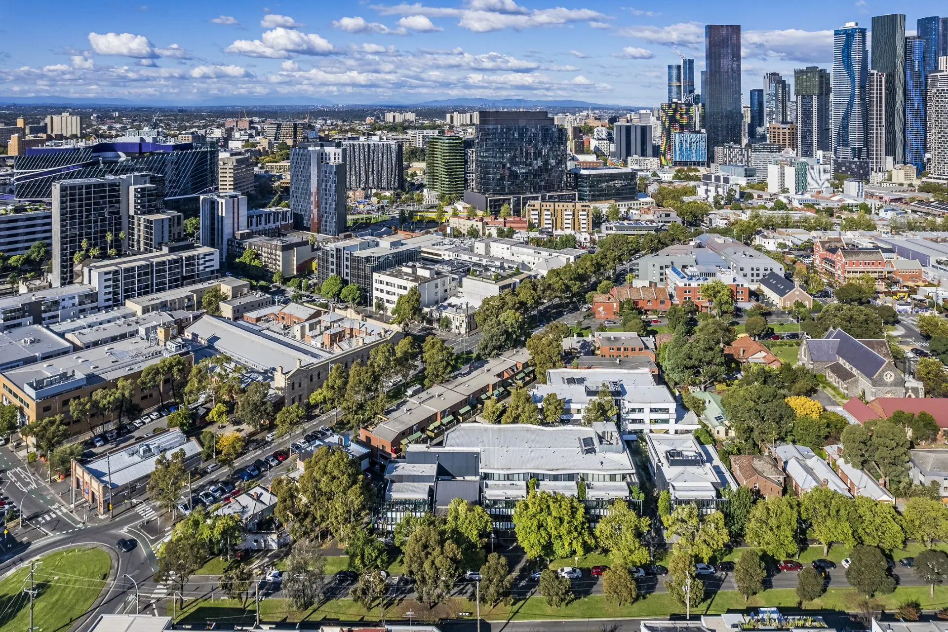 Cityscape with modern buildings and trees.