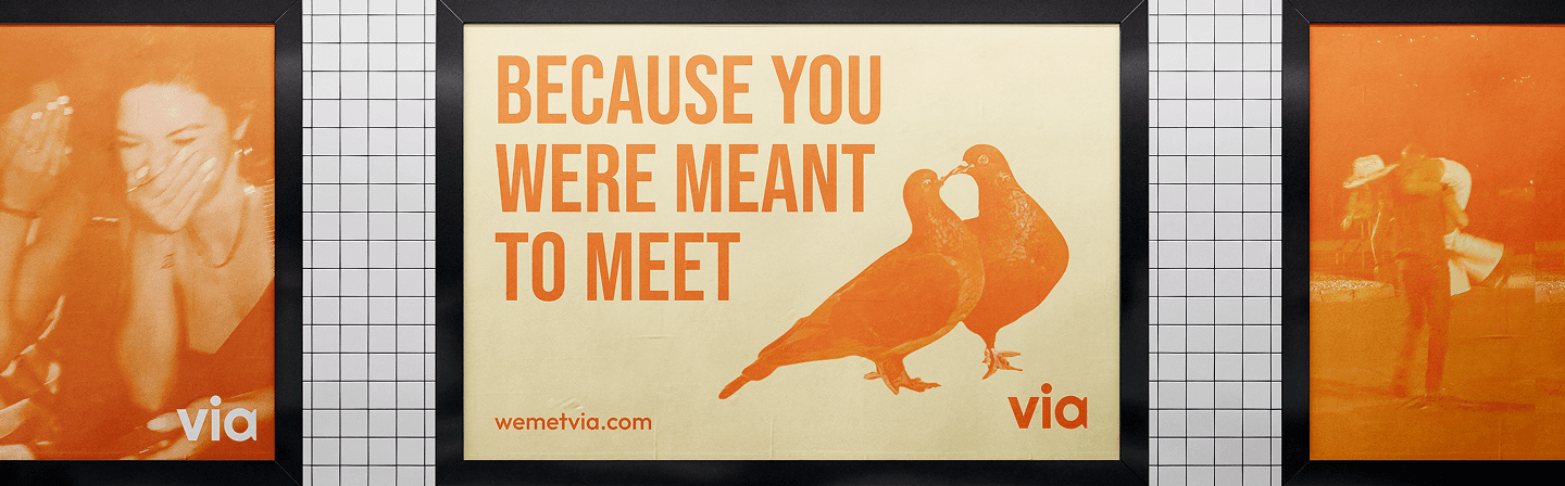 subway scene with via ad that shows two pigeons peck kissing each other and the text "because you were meant to meet"