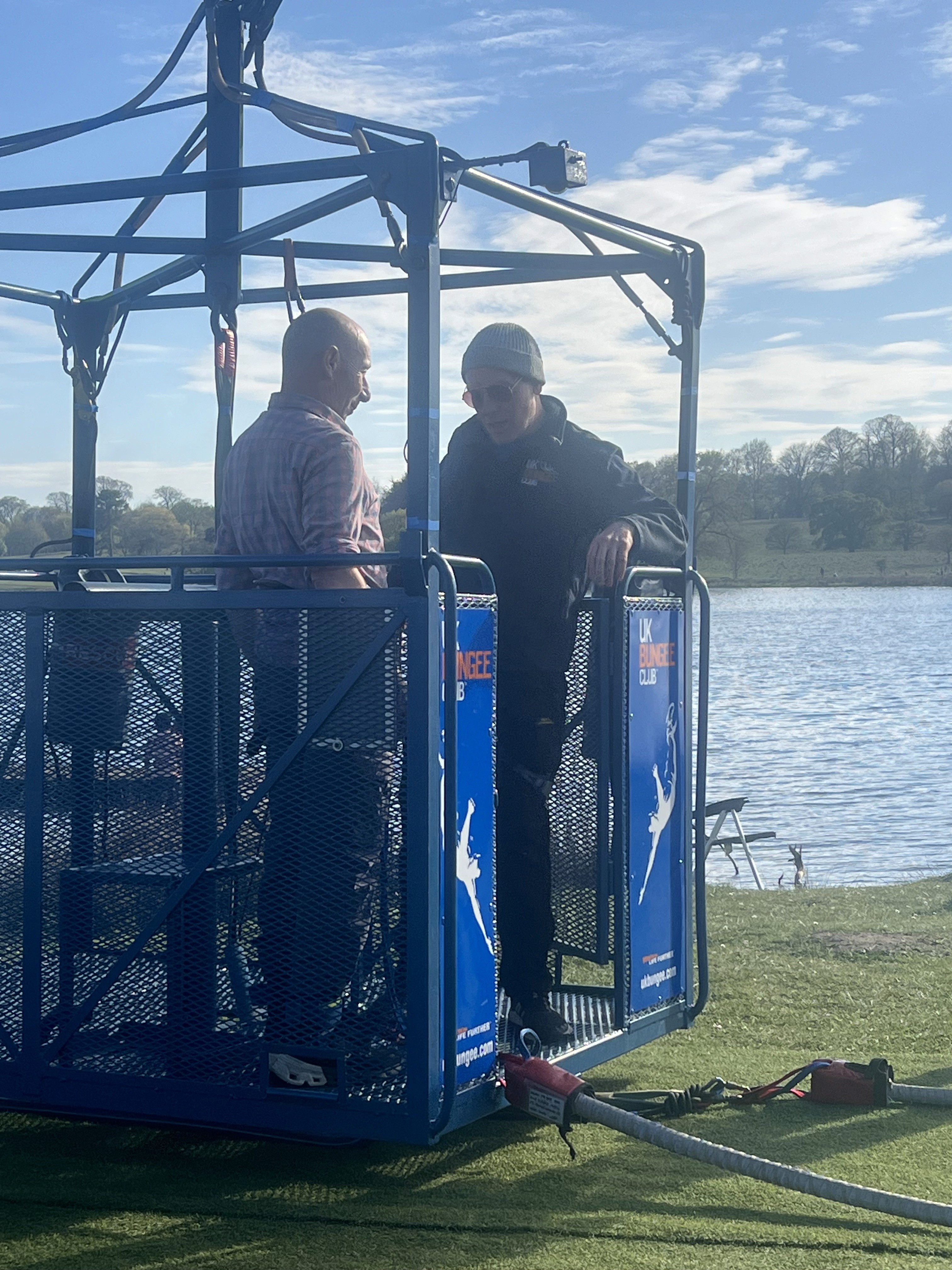 A group of men standing in a blue bunji cage