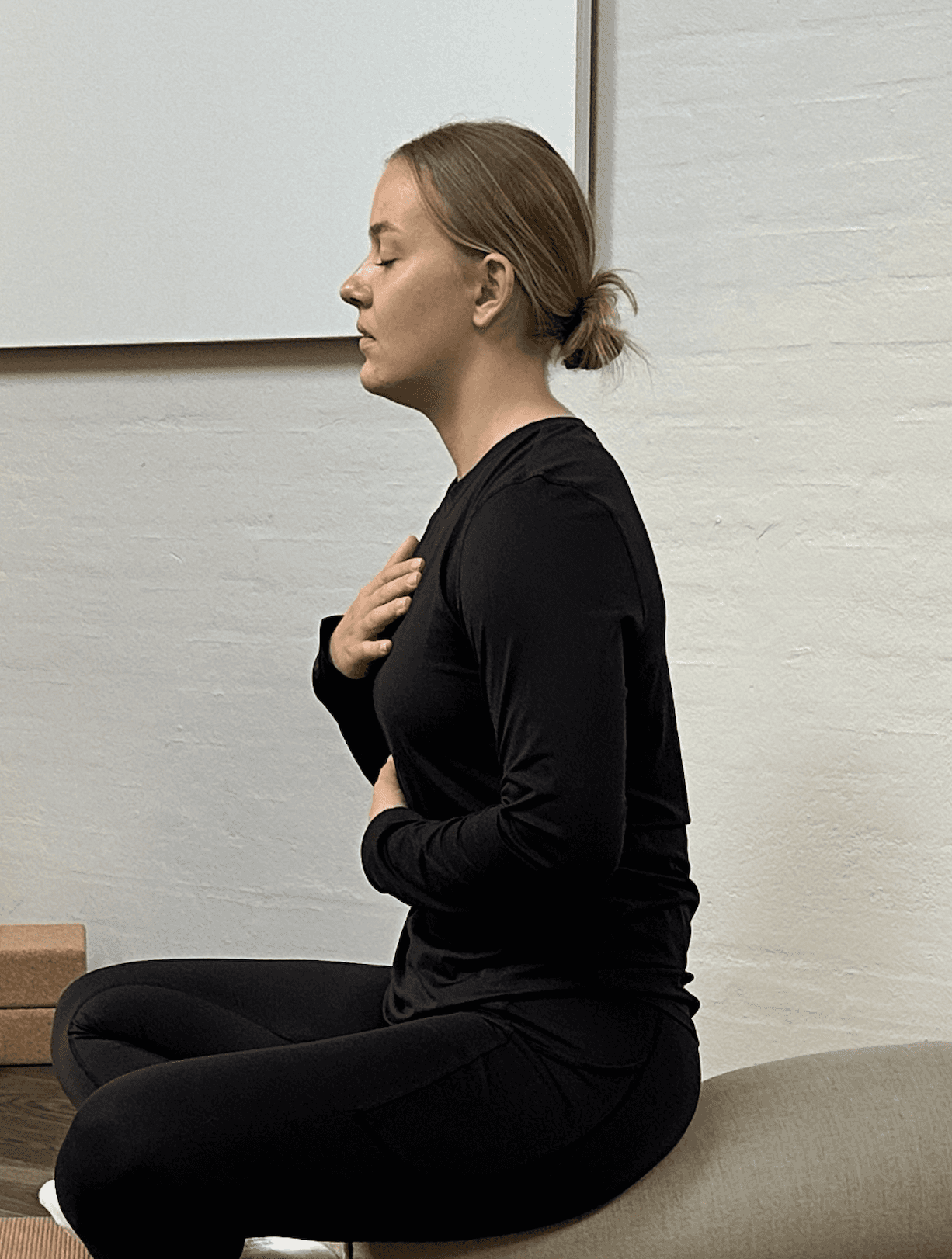 A woman receives a relaxing energy healing in a serene setting with soft lighting.