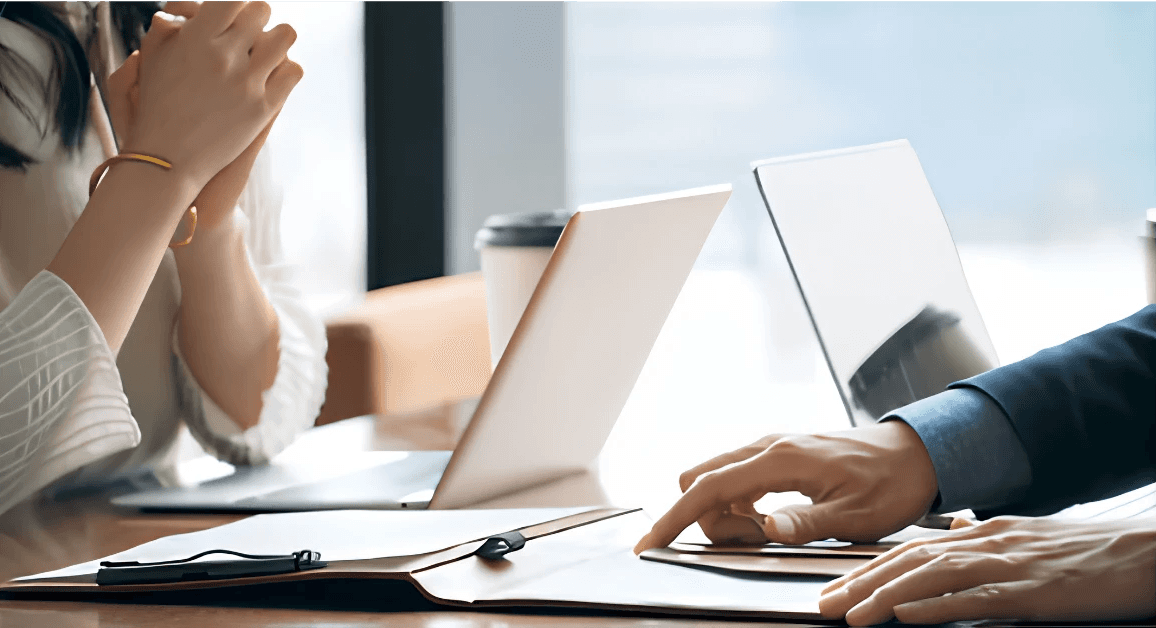 person in black suit jacket holding white tablet computer