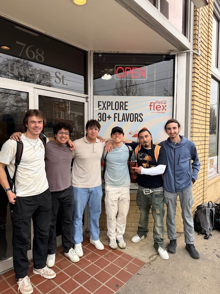 Vintage office with a typewriter, wooden desk, and green leather chair.