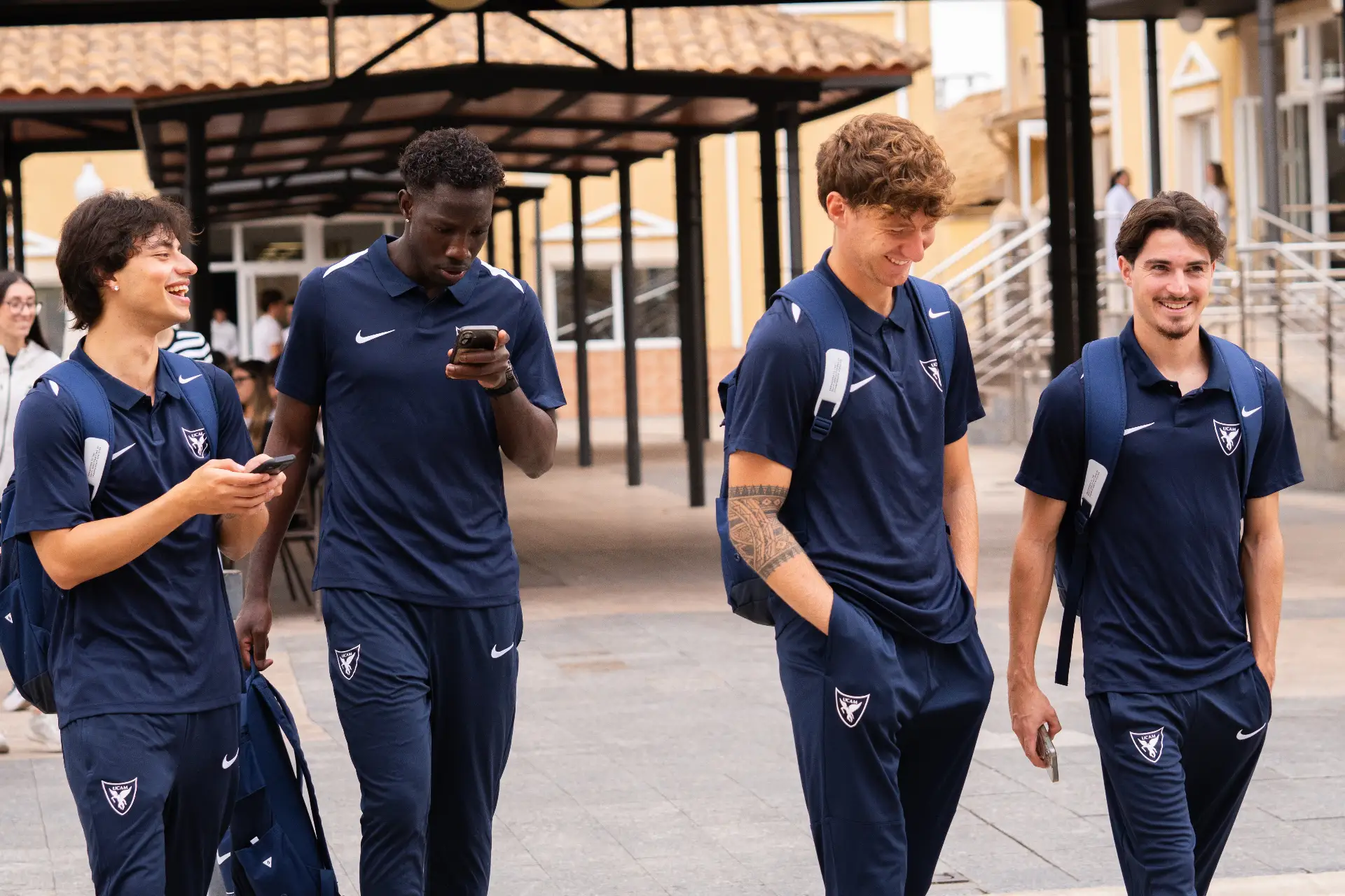 Players of the UCAM International Football Team walking across the university campus before a training session | UCAM Catholic University of Murcia