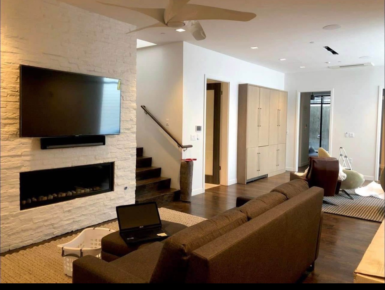 55-inch TV mounted using a over fireplace setup in a residential home in Tampa, with clean wiring and a modern look.