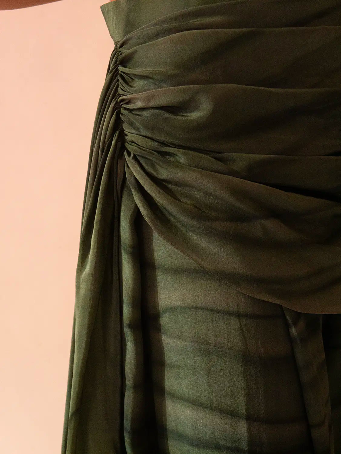 They feature asymmetrical tucks and fluid folds pinned at varying levels,