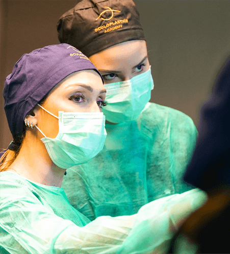 Aerial view of a winding road cutting through rocky terrain with patches of grass.