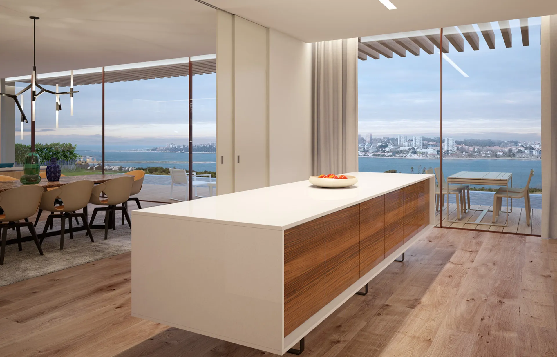 Kadr na wyspę kuchenną w apartamencie z oknami z widokiem na ocean.