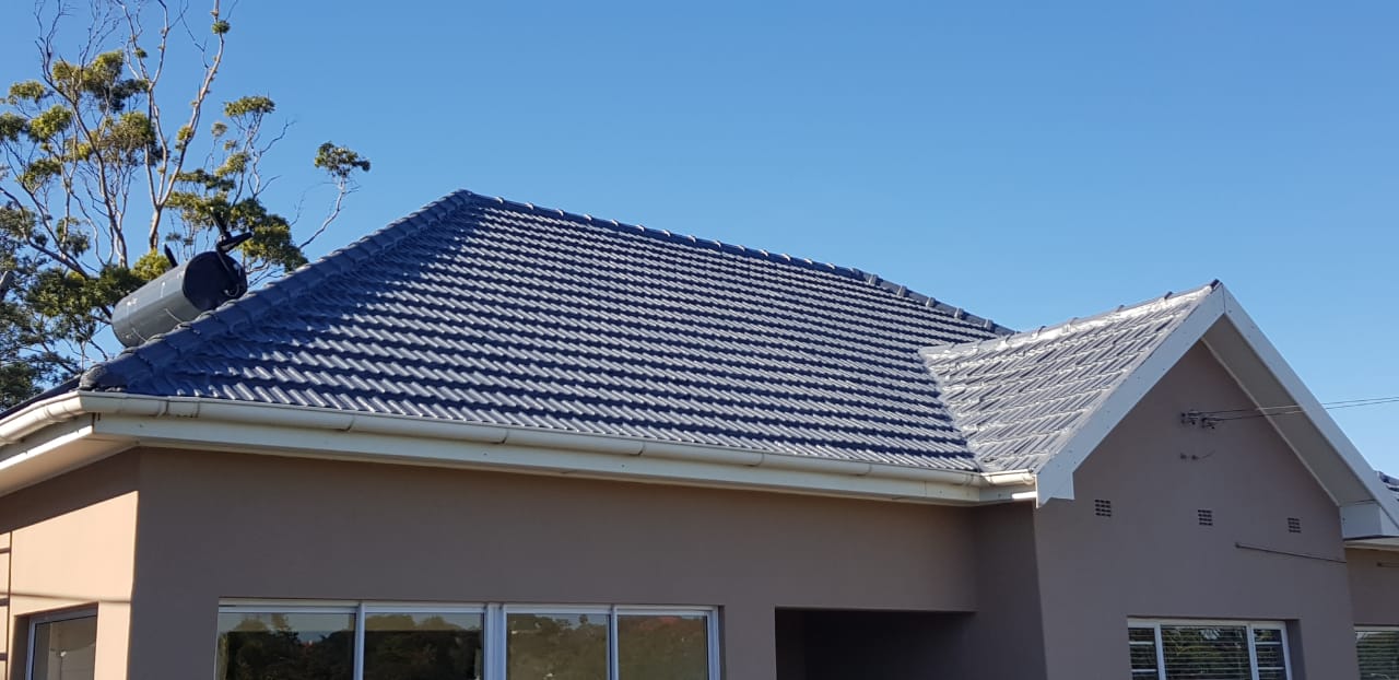 House roof getting sprayed with waterproofiing rubber