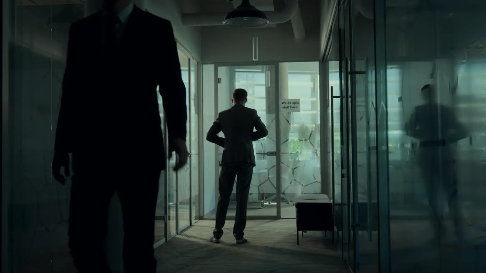 Man in a suit walking down an office hallway in a campaign sketch scene