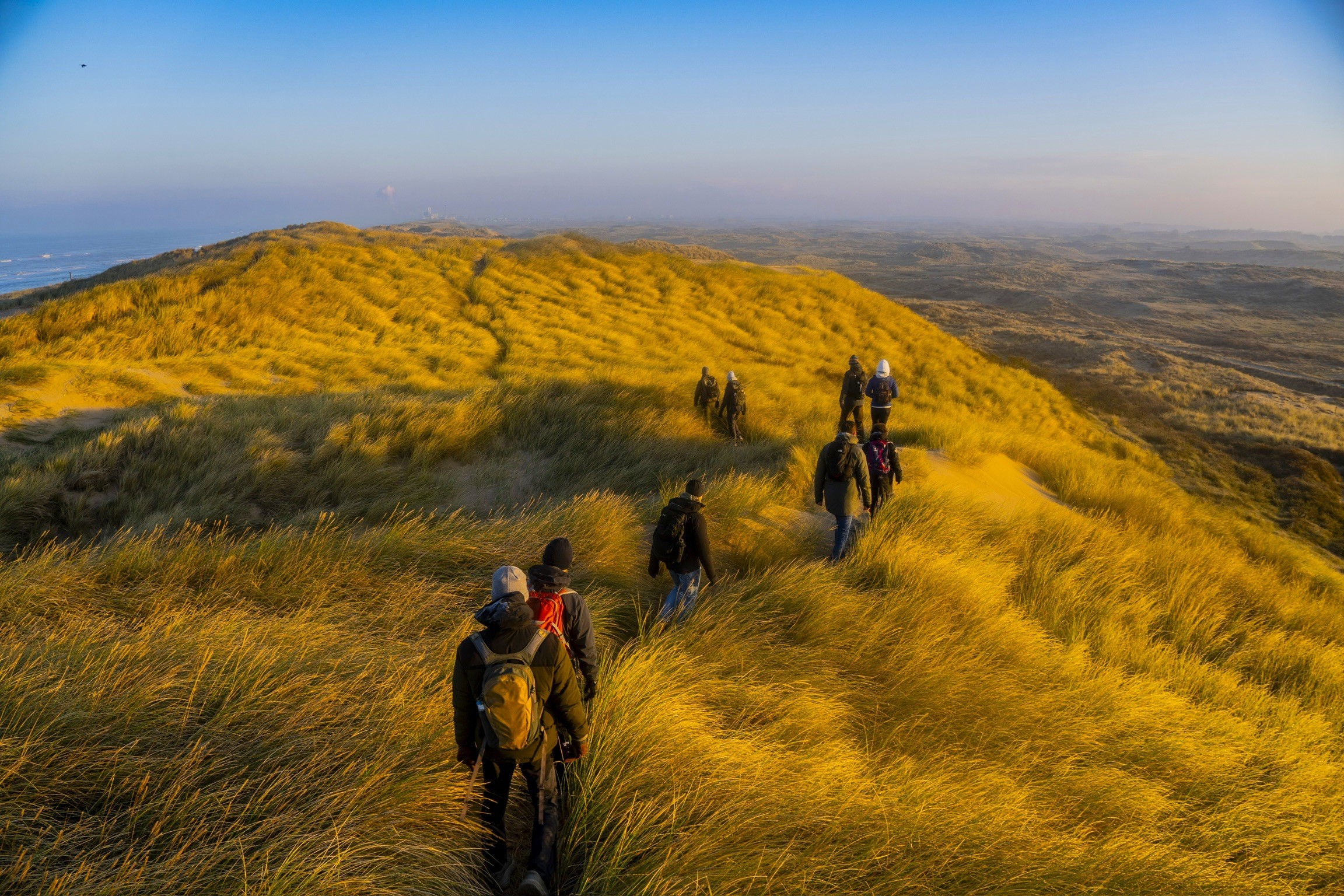 A group hiking trough the Dutch dunes