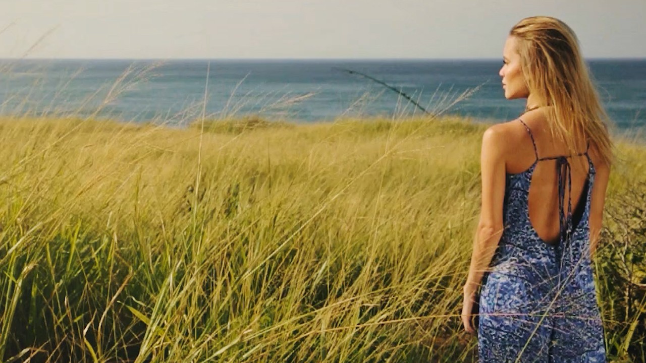 Editorial fashion film of a woman wearing a blue dress in an open field