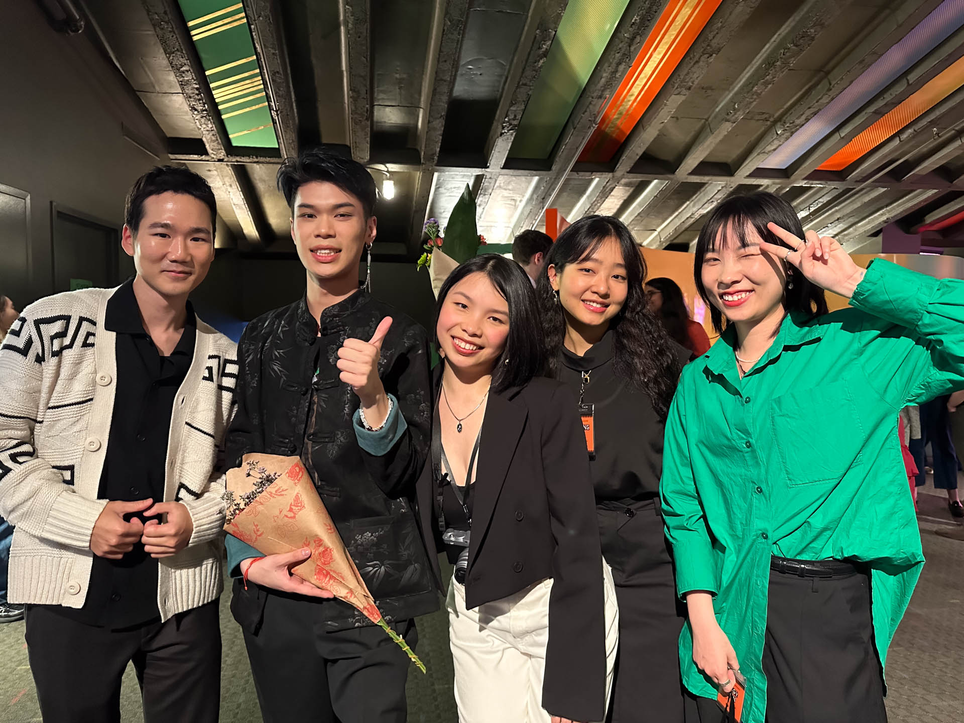 a group of students smiling for the camera in the SVA Theatre lobby after the Venture Forum