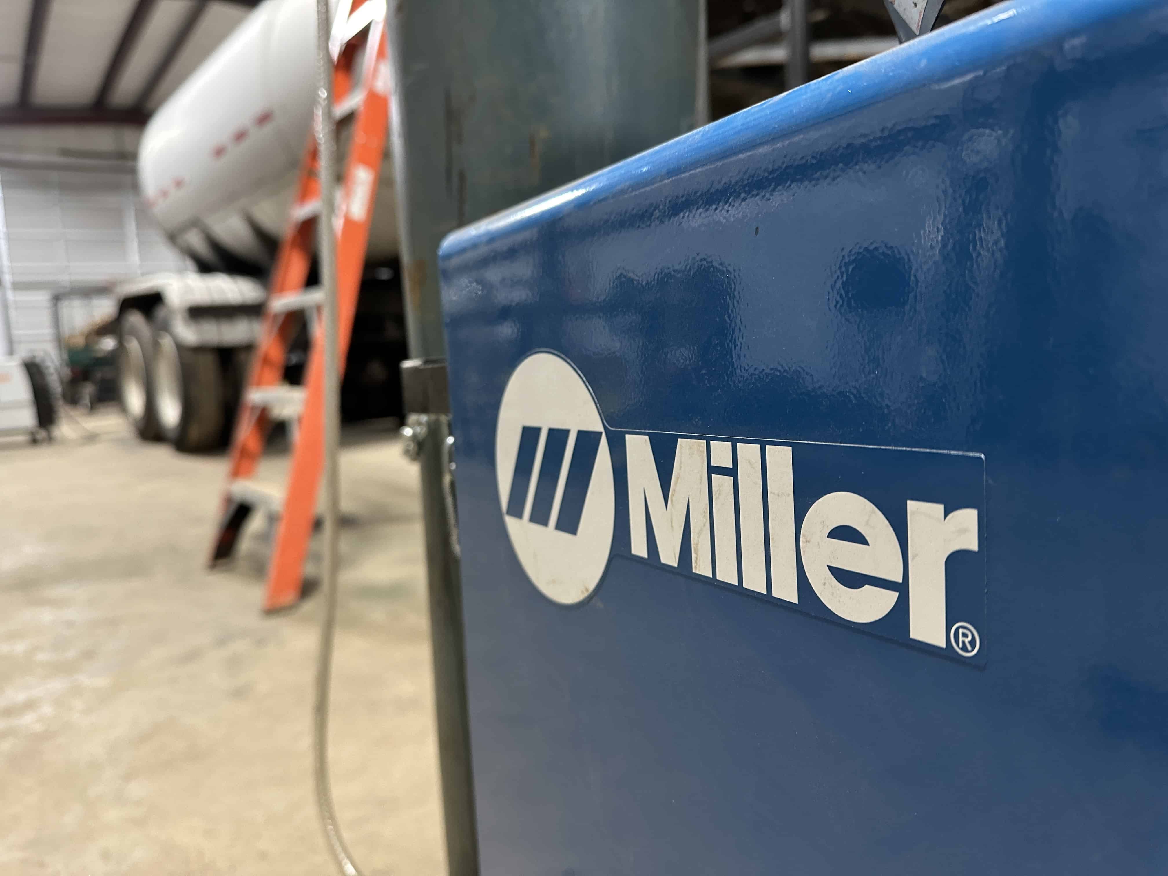 Our Miller MIG welding machine is in the forefront of this photo with client's 18 wheeler trailer project we are welding a ladder and bumper onto is in the background. This image shows our welding services capabilities in Henderson, Tx and the surrounding East Texas areas.