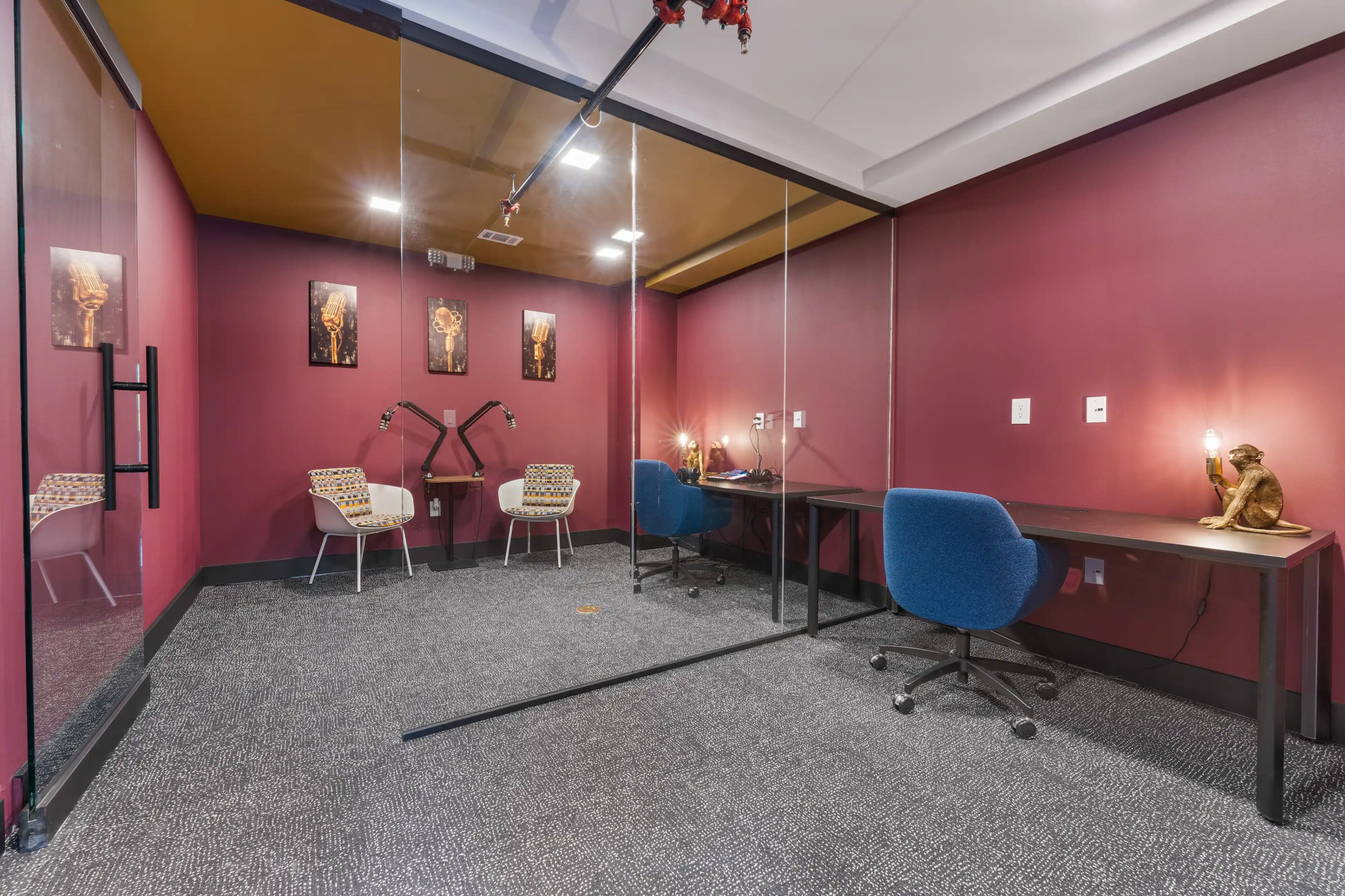 A private podcast studio featuring a desk and two chairs, designed for recording and discussions.