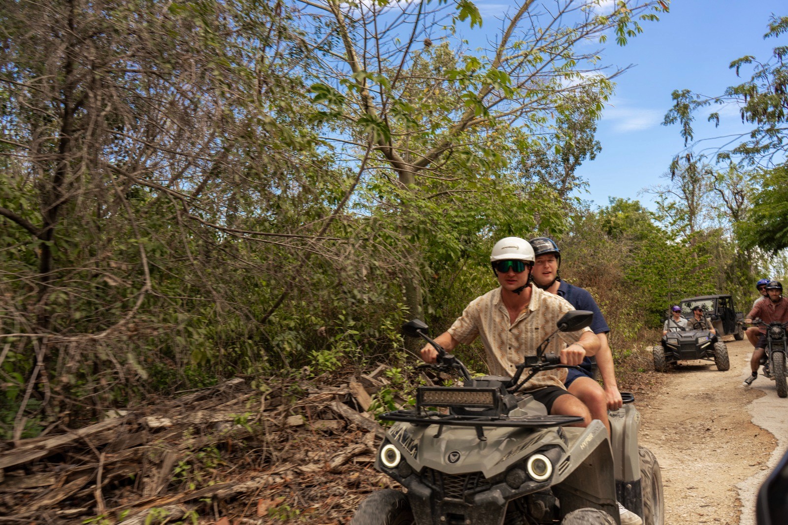 Two happy men driving a sportscar with a joyful expression, ideal for car rental adventure promotions