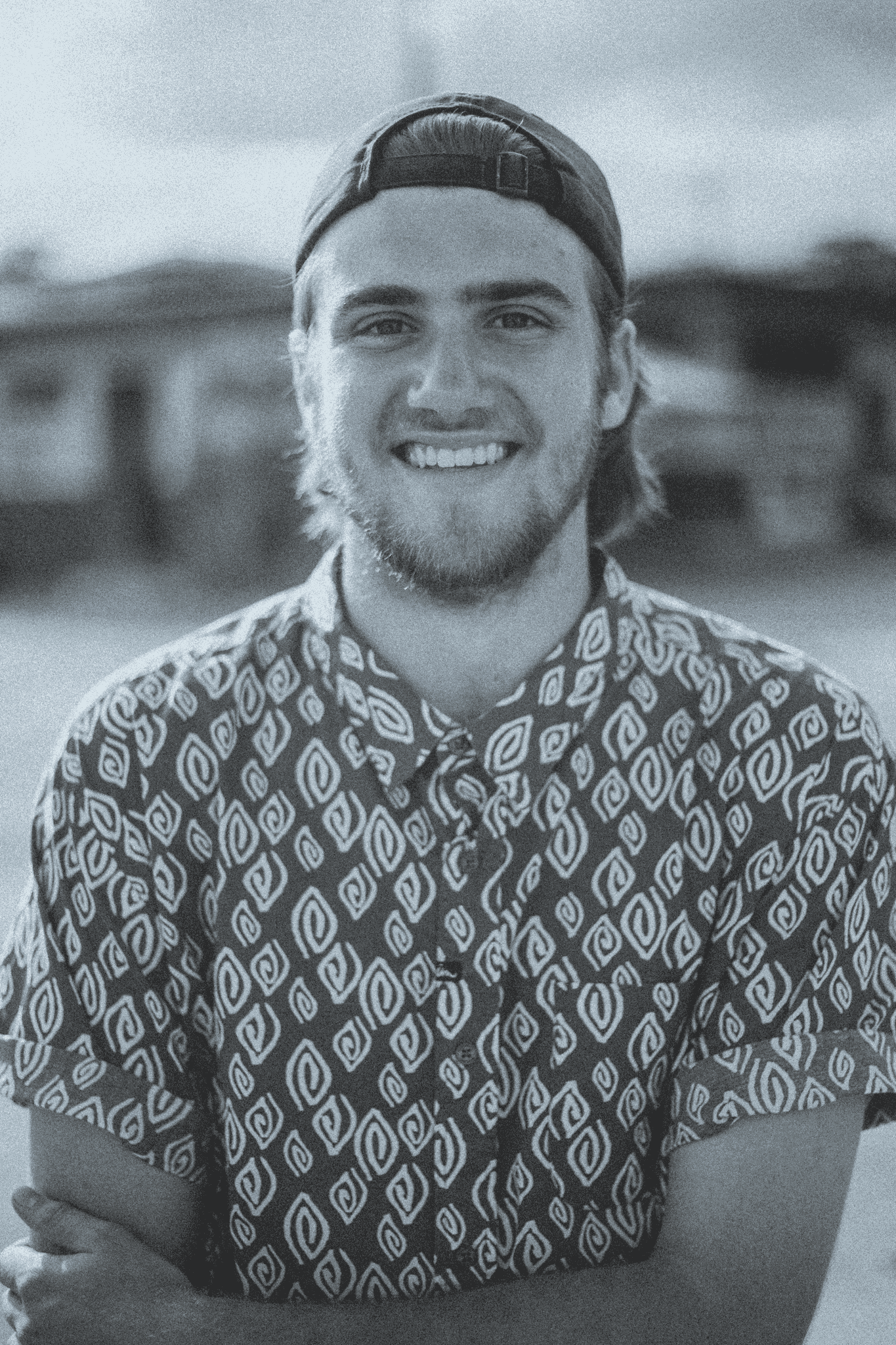 Portrait of a person in dark clothing speaking on a phone