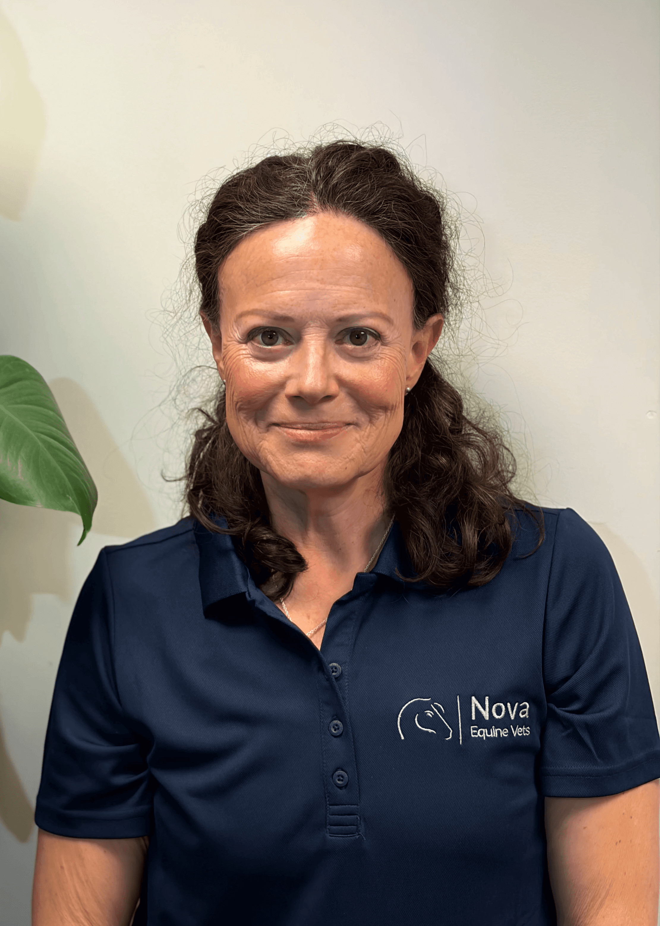 a man in a blue shirt smiling at the camera