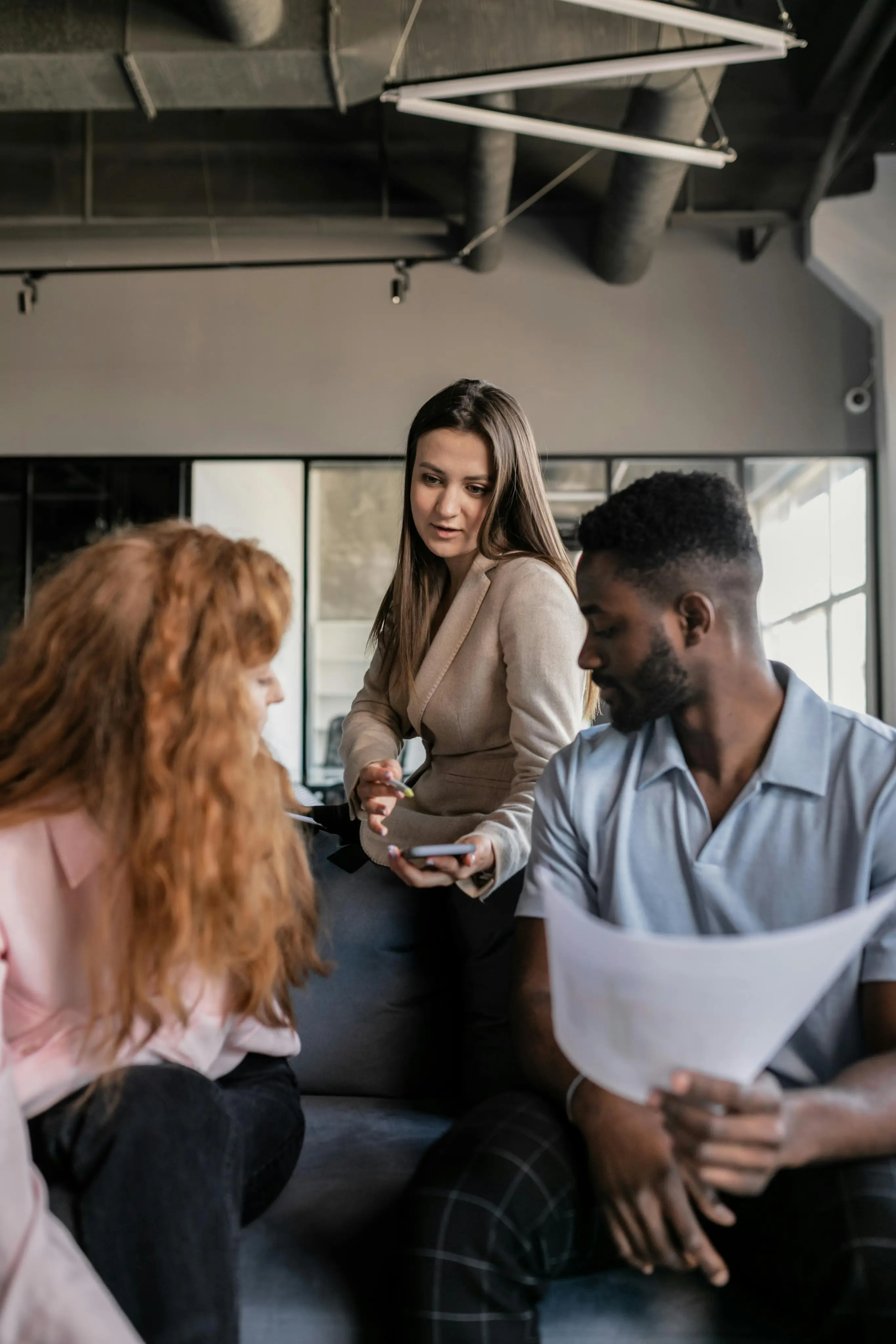 Group of people chatting and laughing together in a casual indoor setting