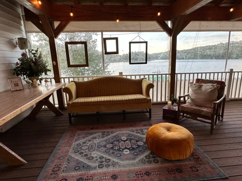 Cozy lakeside porch lounge at Camp Lenox