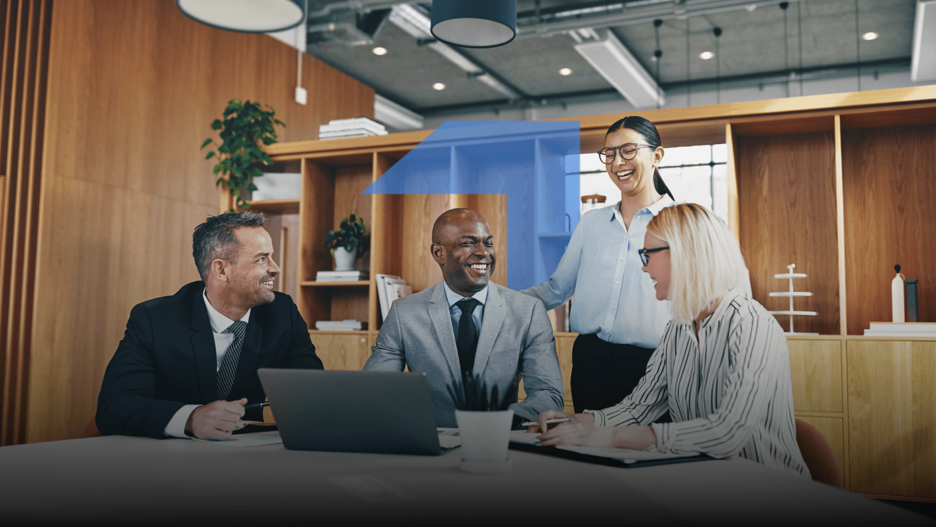 A group of people in an office setting, discussing and smiling
