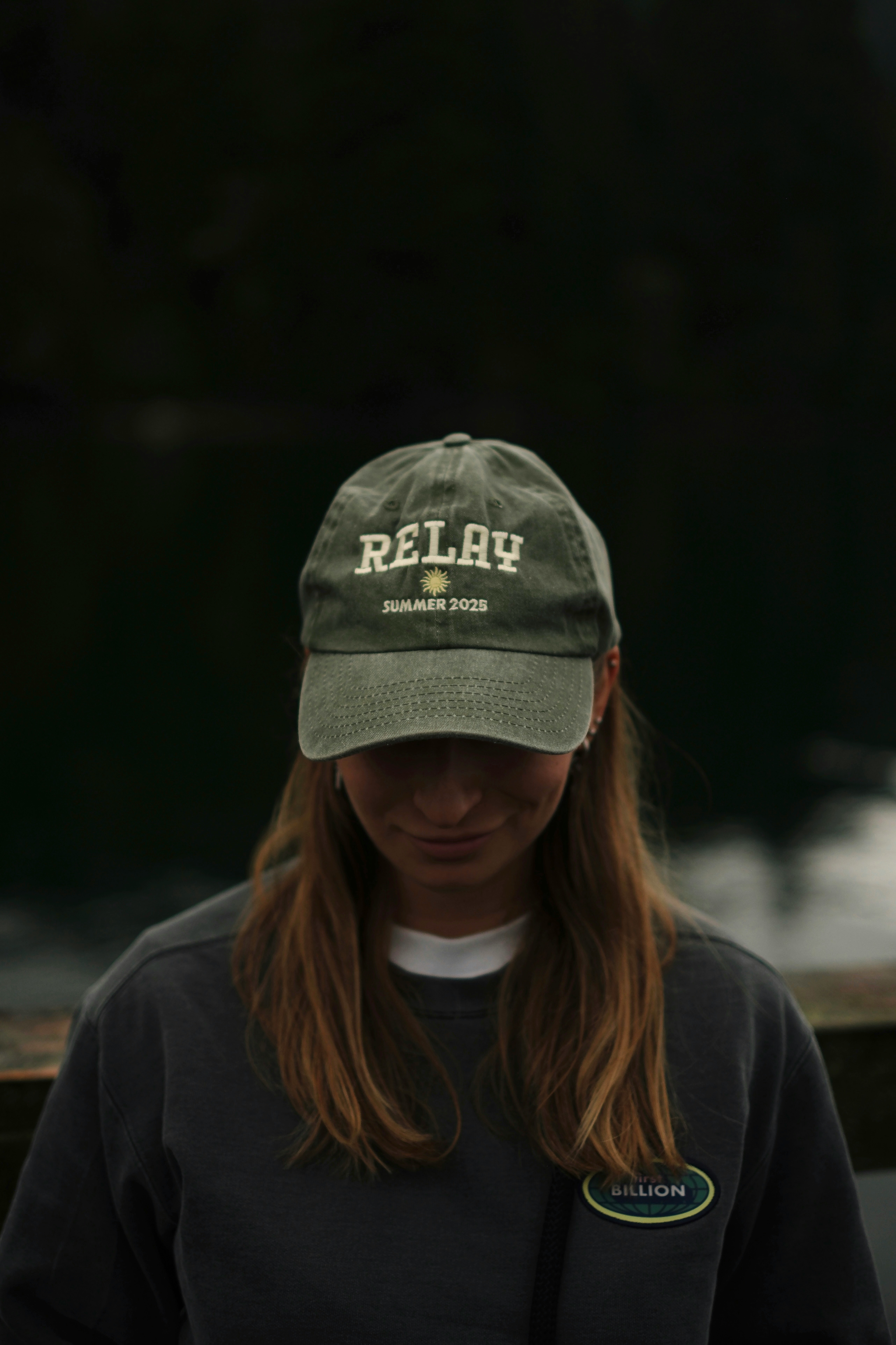 Young woman wearing a green baseball cap