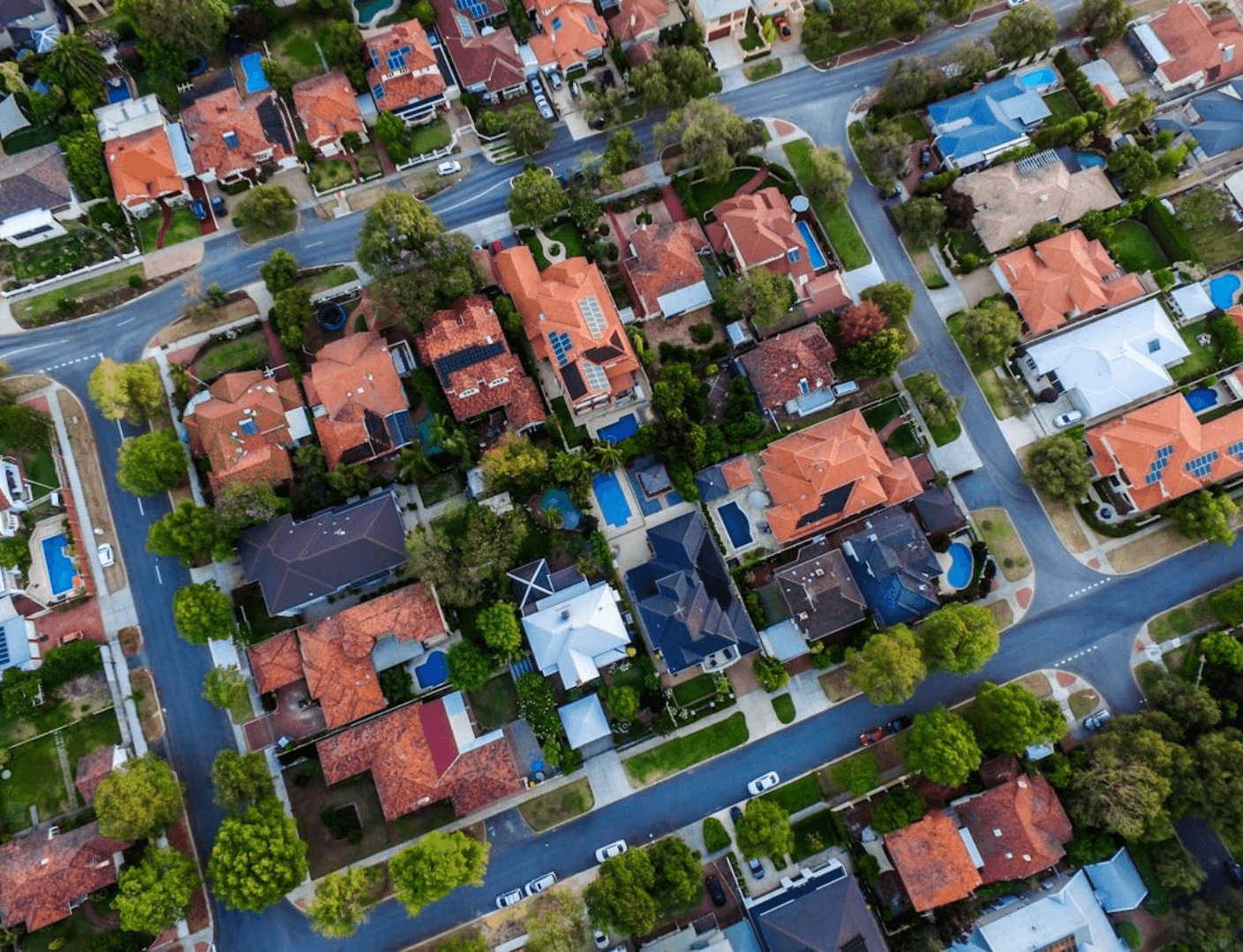 Aerial view of suburban neighborhood with houses and streets.