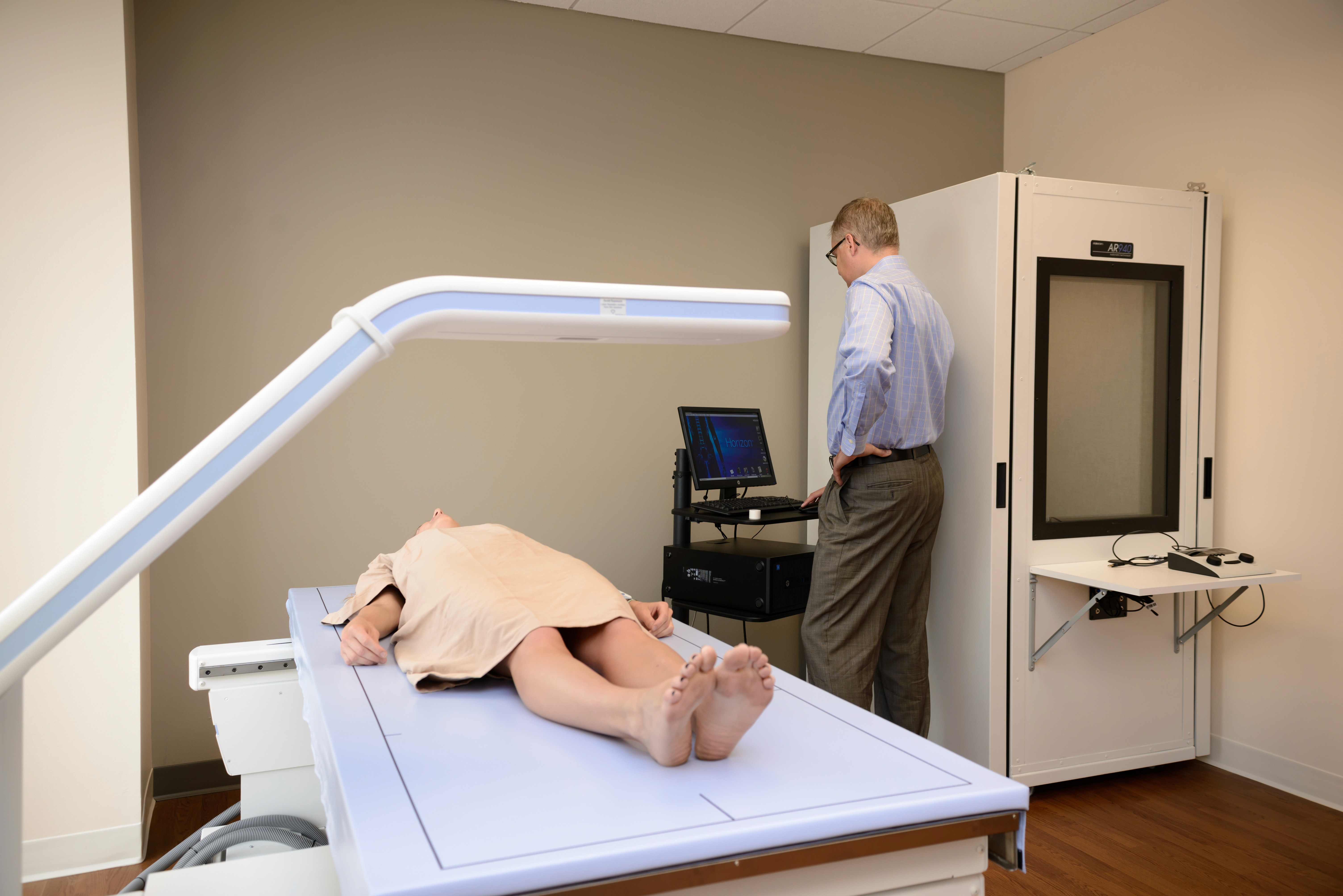 Patient completing DXA body composition test as part of Harper Health fitness assessment.