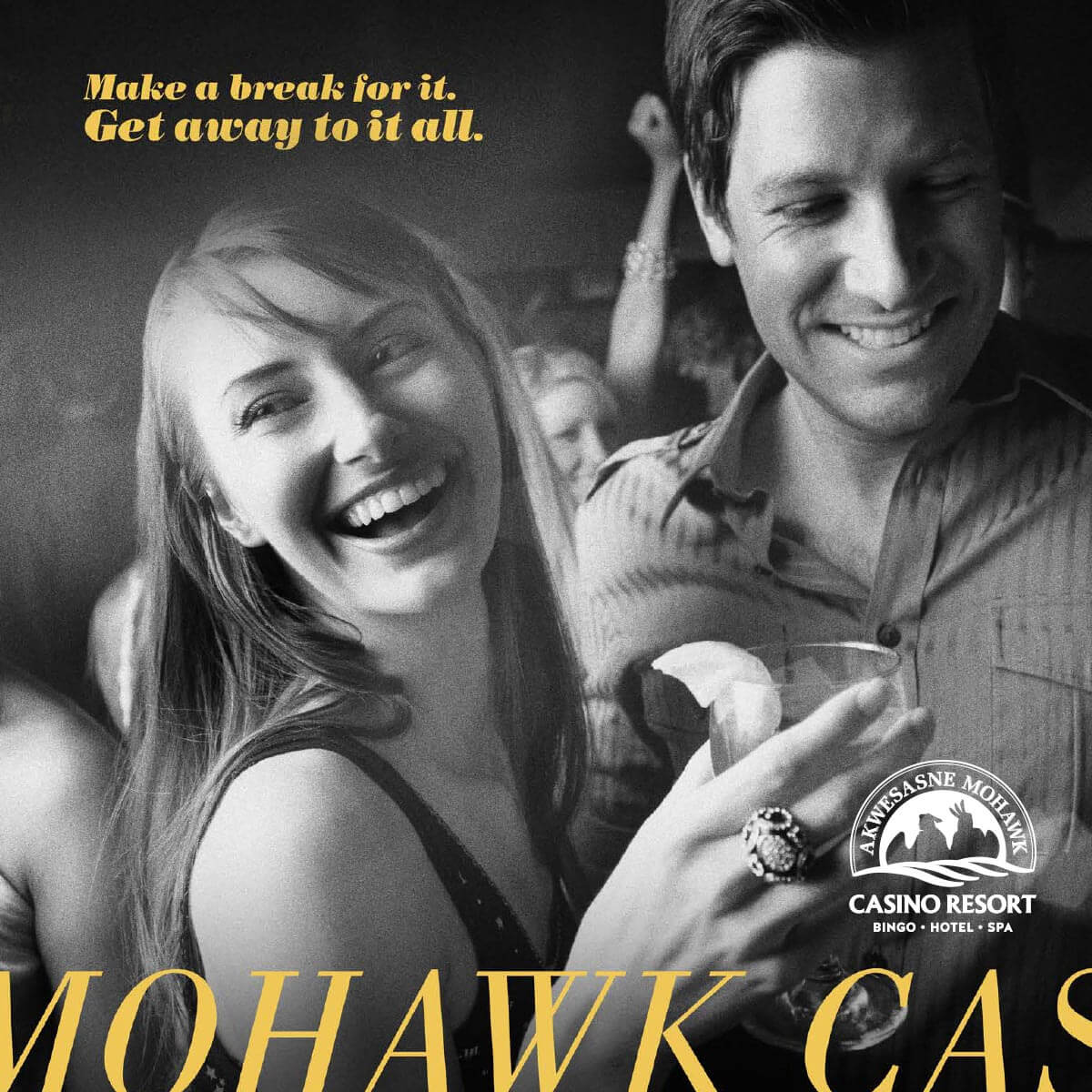 A smiling woman and man enjoy drinks at a lively social event. Text on the image promotes Akwesasne Mohawk Casino Resort.