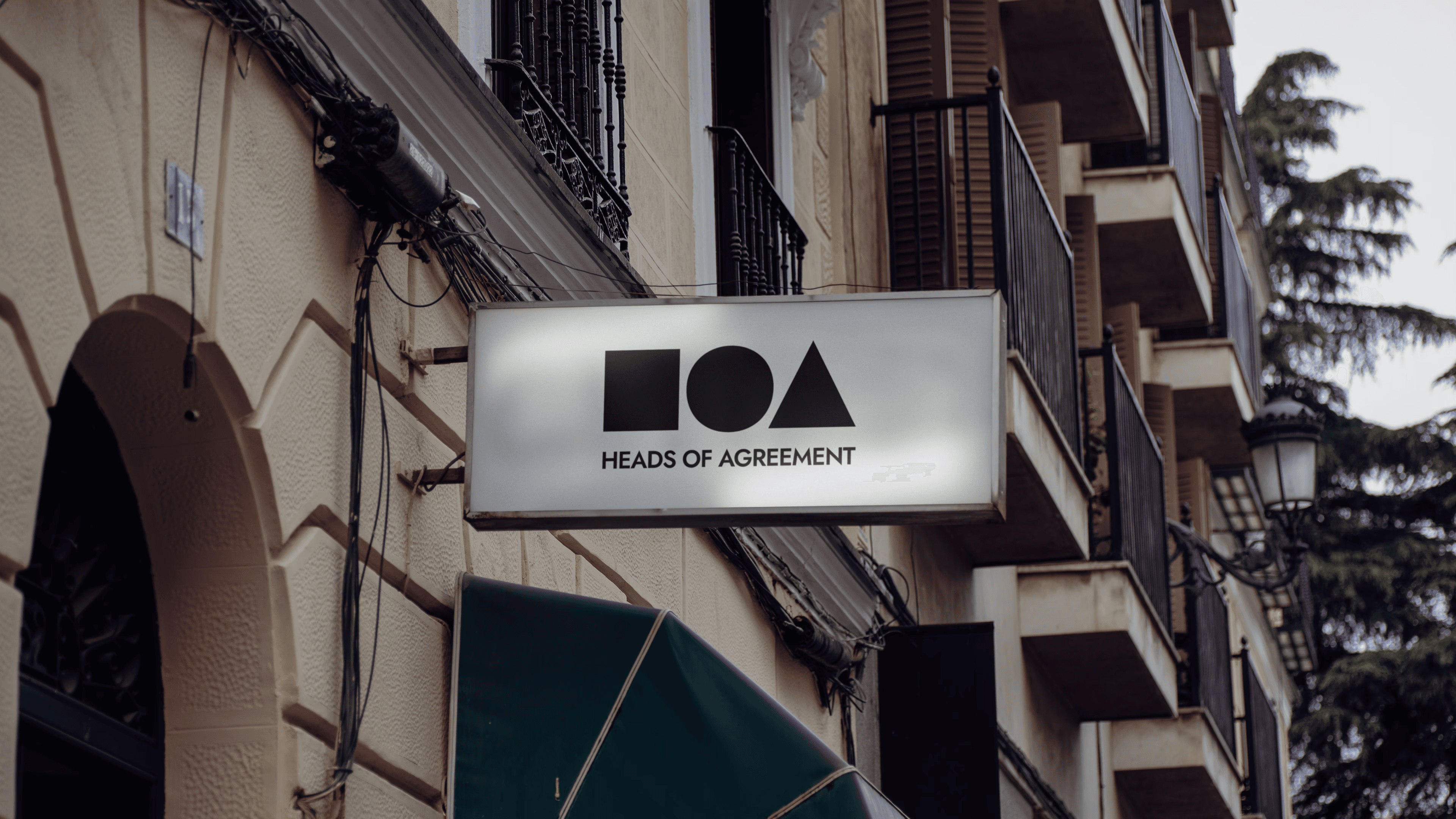 The white logo of luma room on a  green background