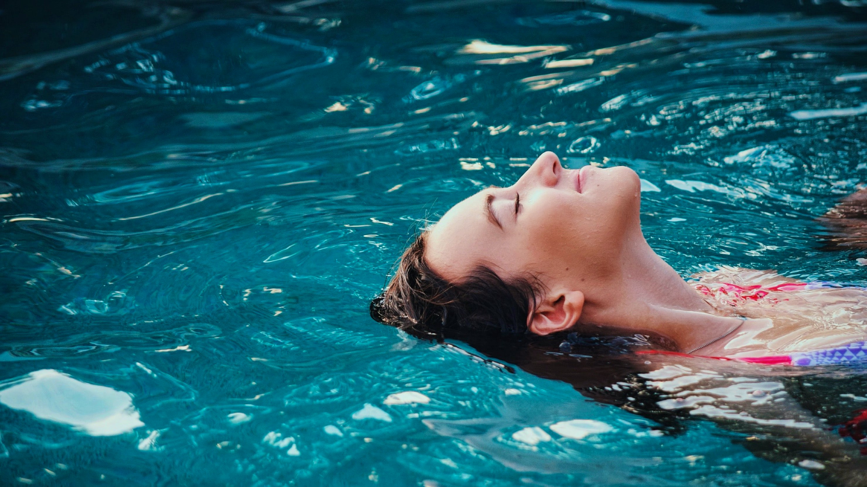 VakantieVeilingen.nl — woman swimming on her back in a swimpool in a sunny environment — Soda Studio case study