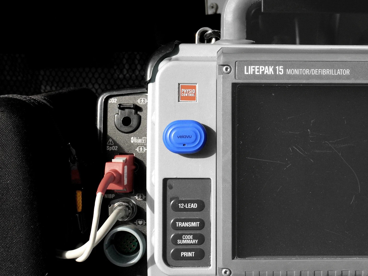 Velavu Arda attached to a defibrillator in an ambulance
