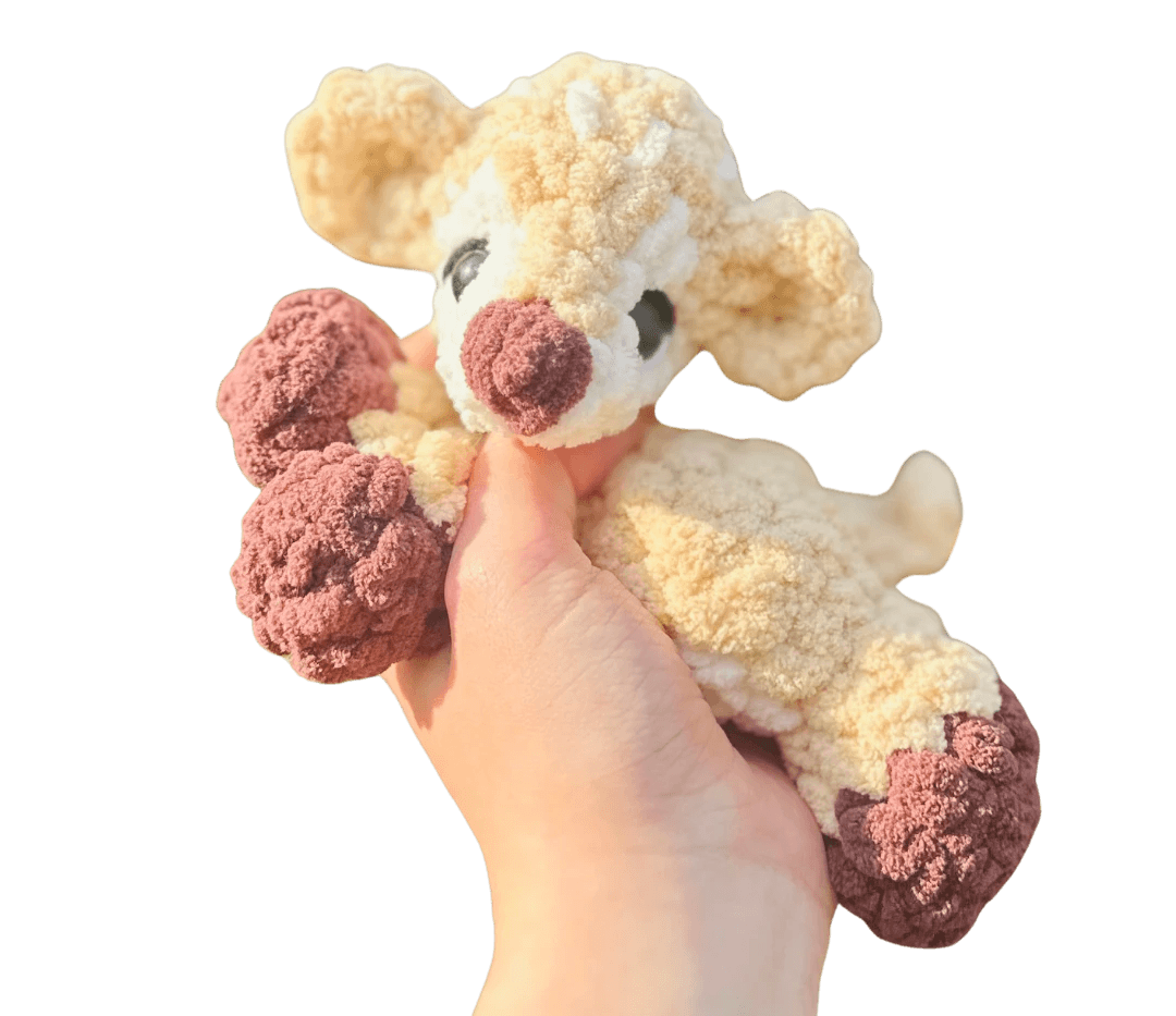 A cute, handcrafted plush acorn toy with brown yarn spikes and large, friendly eyes sits facing forward on a white background.