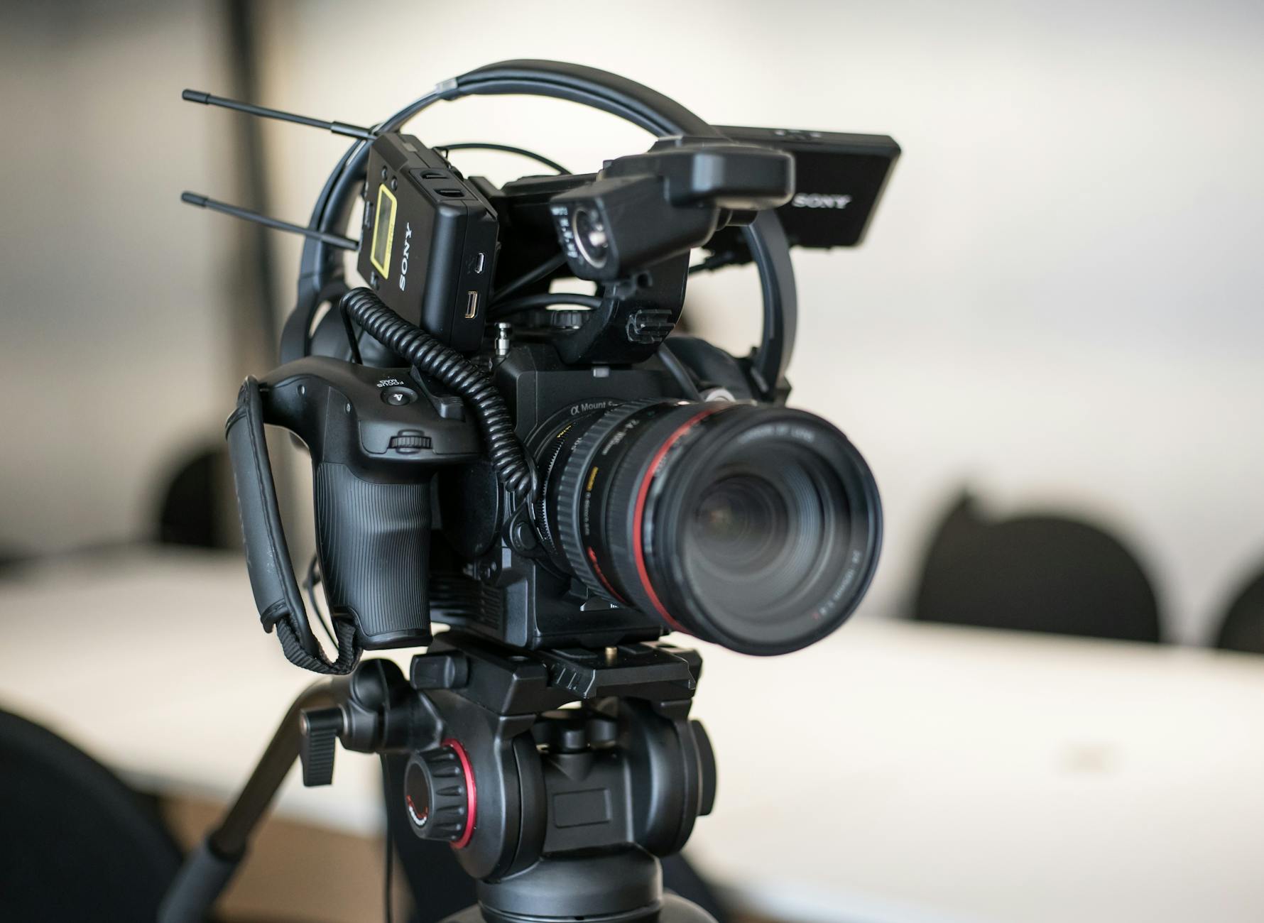 A female teacher wearing a headset recording a lesson using educational technology tools on her desktop computer.